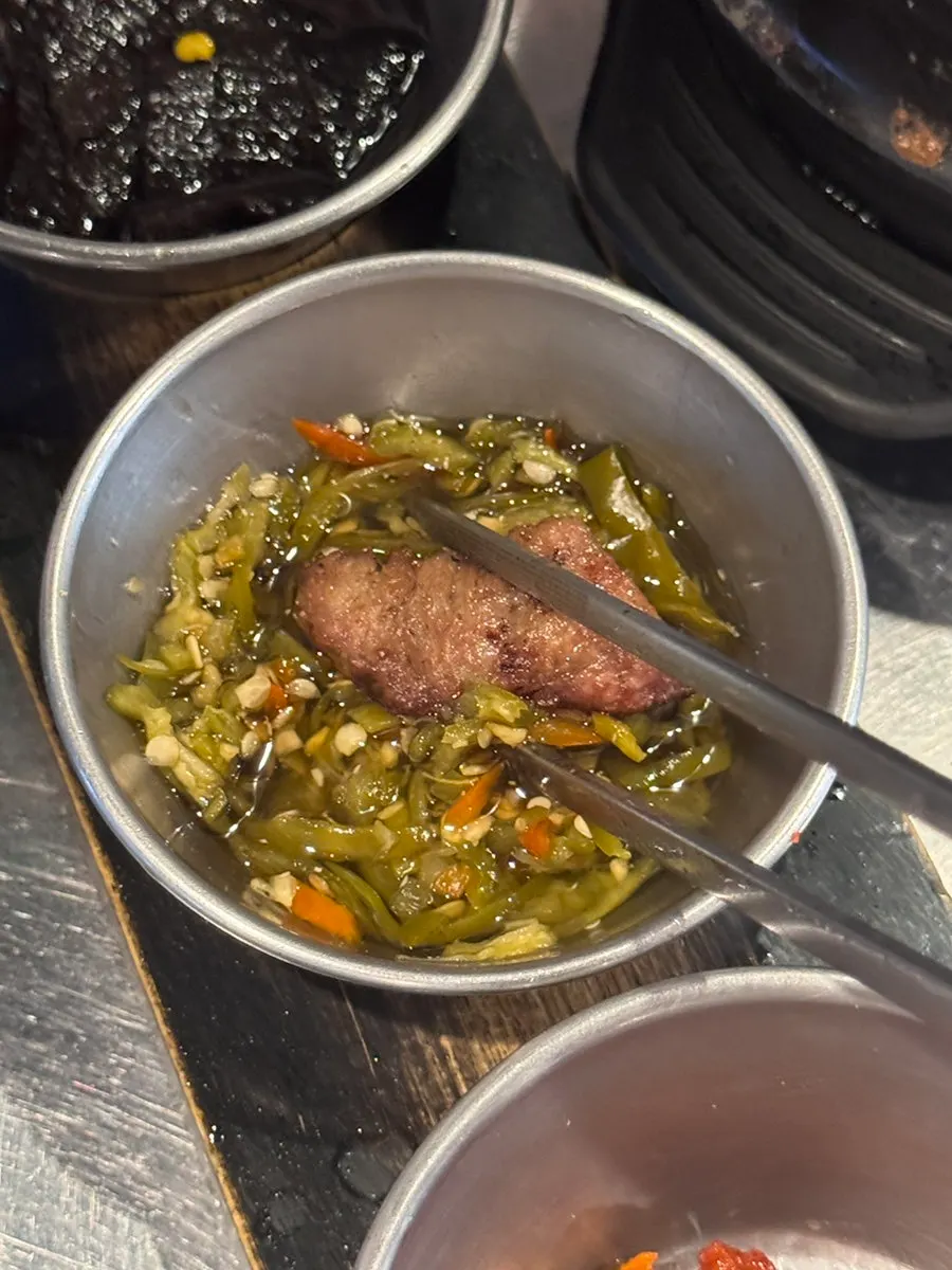 Grilled pork neck dipped into various sauces