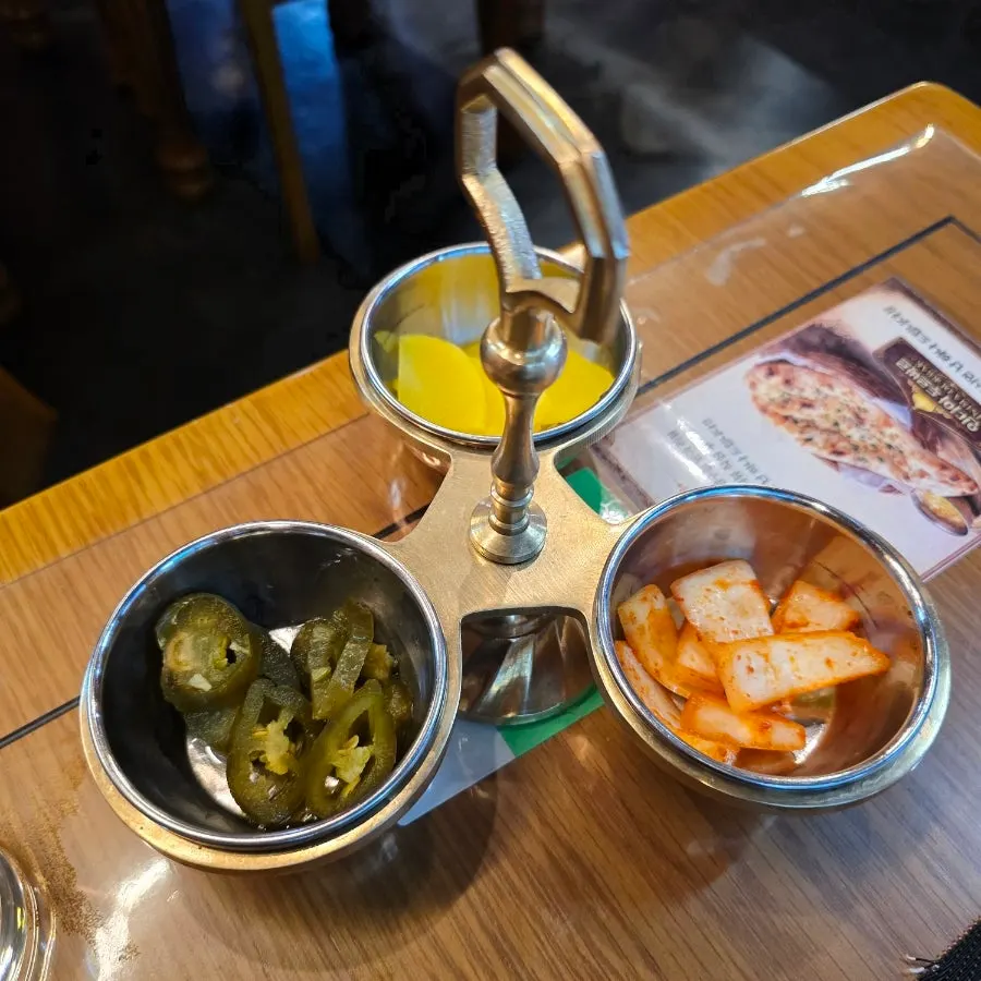 Side dishes of pickles, danmuji, and pickled onions