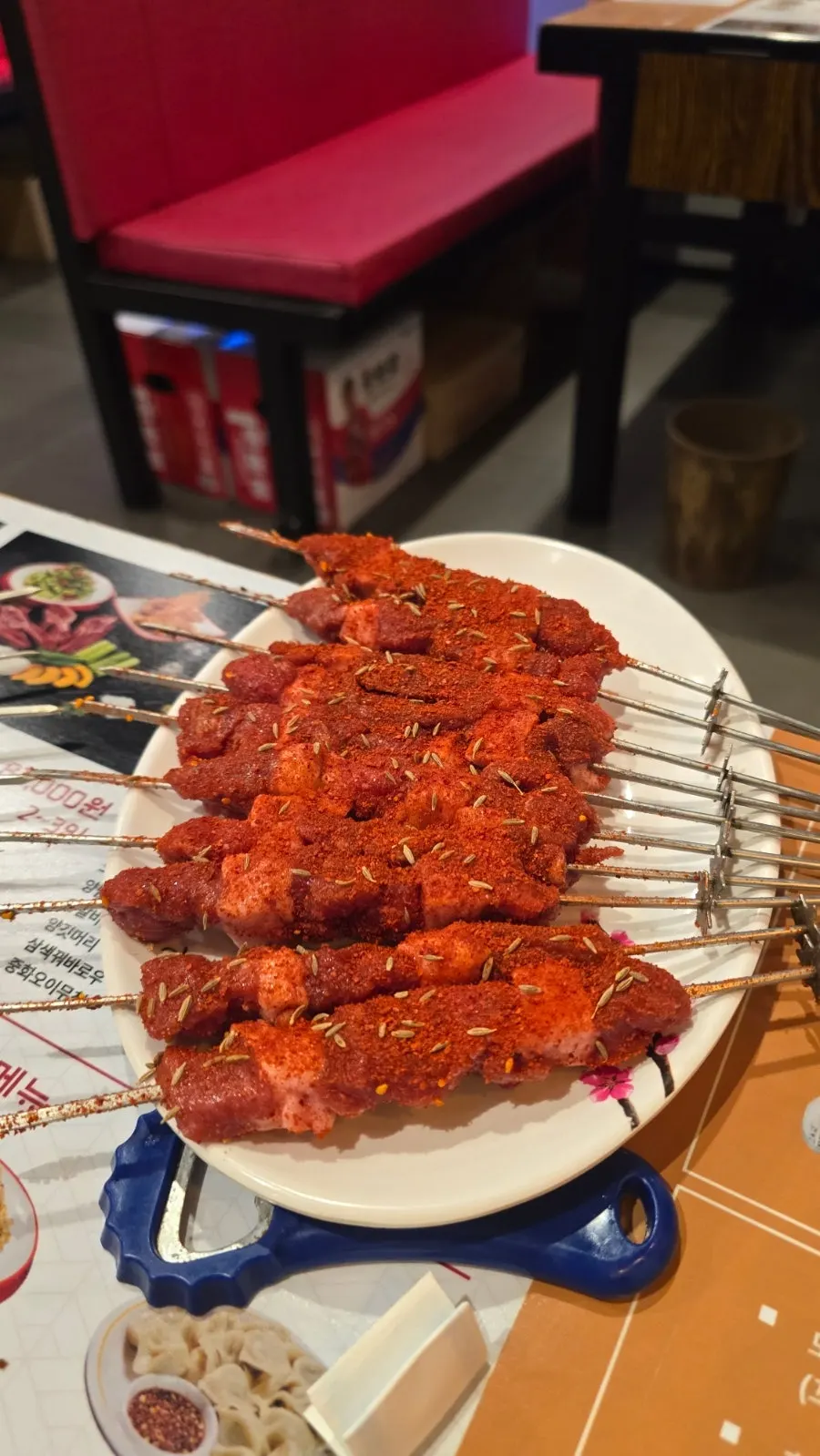 Plate of vivid red raw lamb skewers