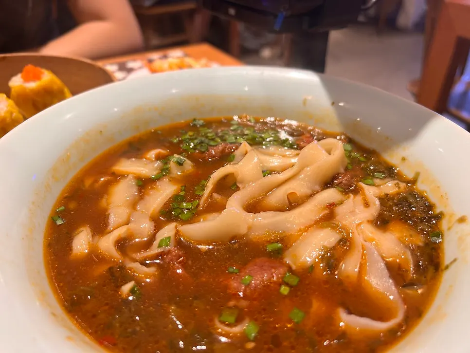 Broth from the Sichuan-style spicy beef knife-cut noodles