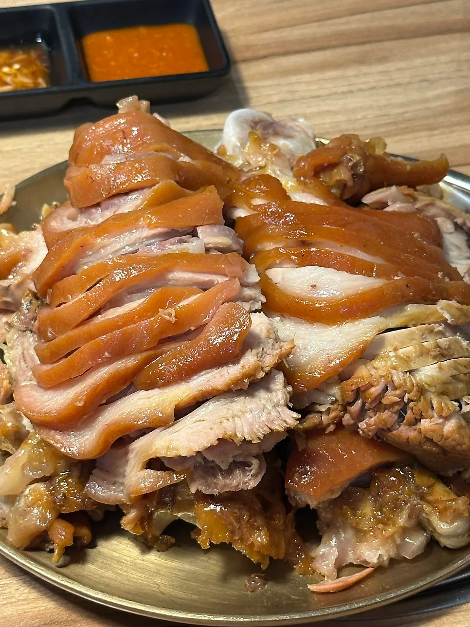 A piece of jokbal dipped in shrimp sauce