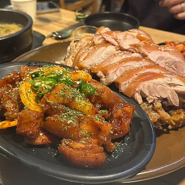 A plate of cold jokbal topped with seafood and vegetables