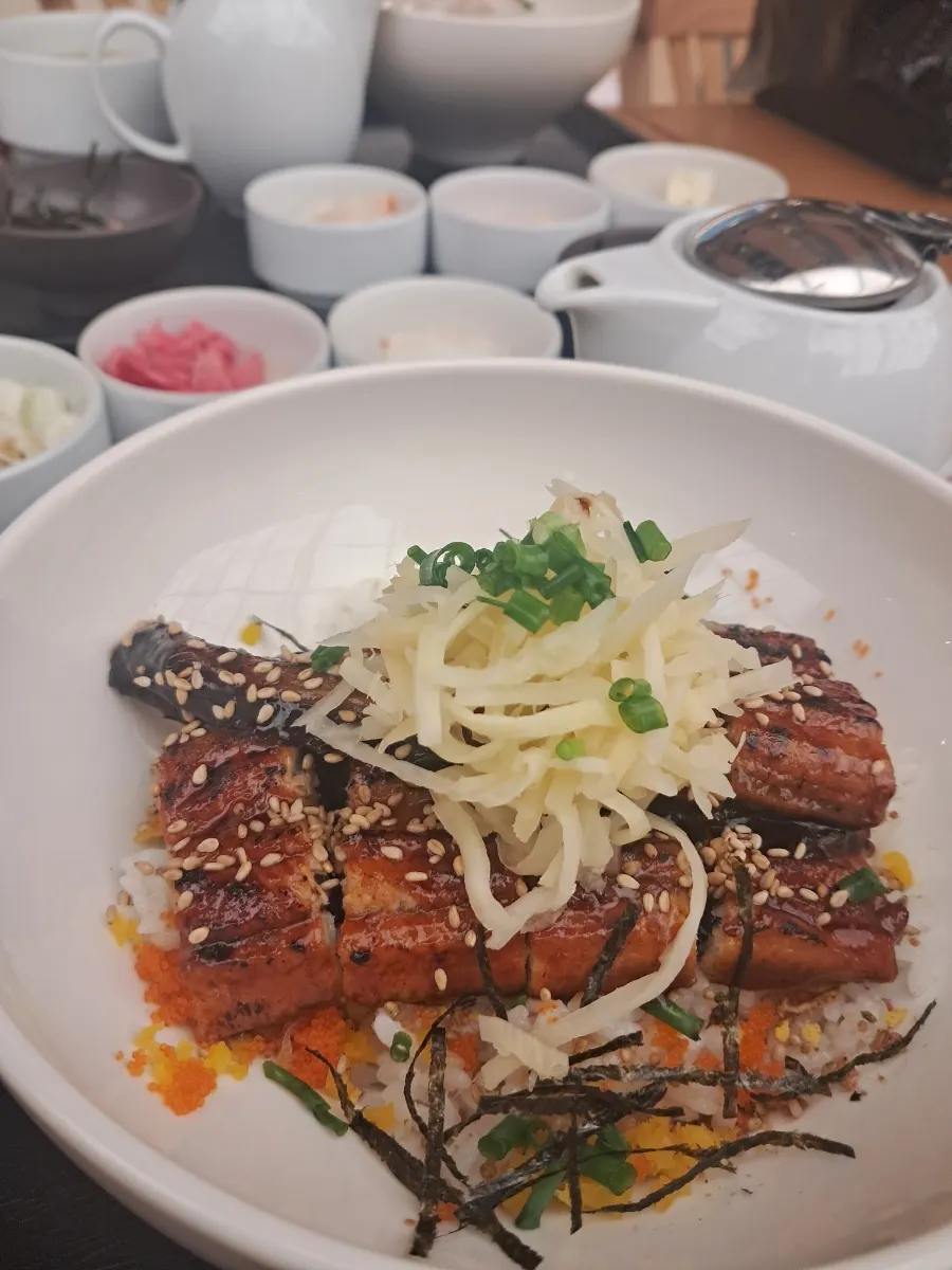 Close-up of salmon rice bowl topped with flying fish roe and pickled onion
