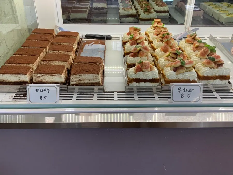 Cakes topped with fresh fruit on display