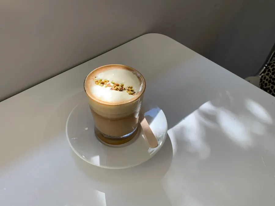A glass of pistachio cream latte