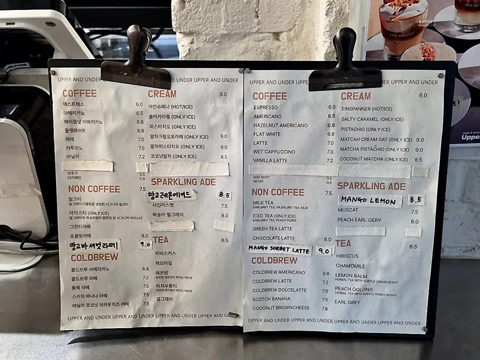 Café menu board listing coffee and cream drinks