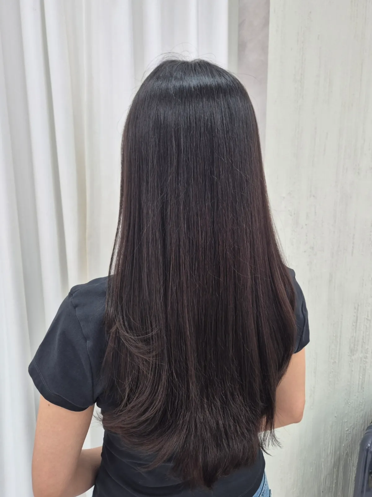 Back view of long hair reaching the waist after the clinic