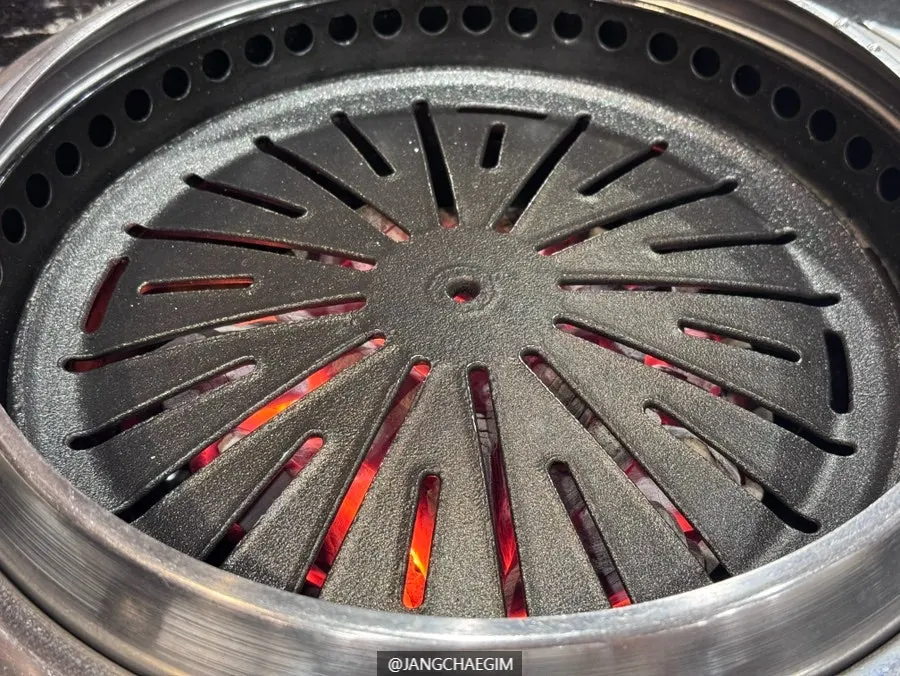 A grill with lit charcoal