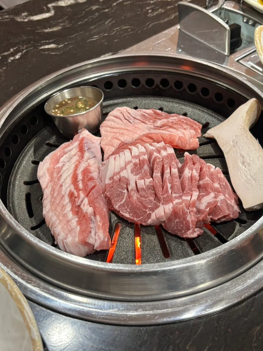 Staff grilling meat on the grill