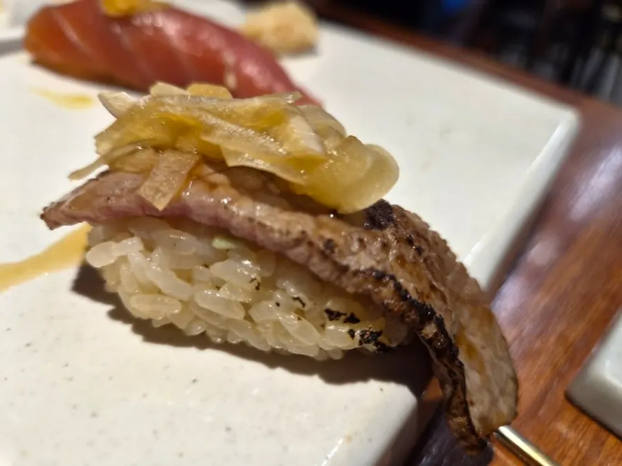 A piece of Shirokuma's beef sushi