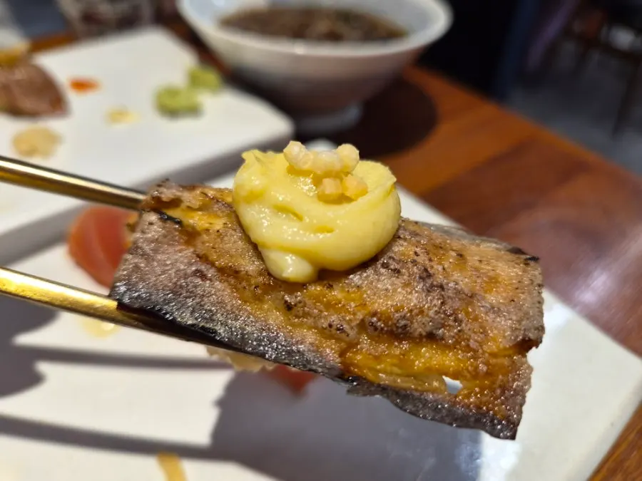 Shirokuma's eggplant sushi topped with a lemon-colored sauce