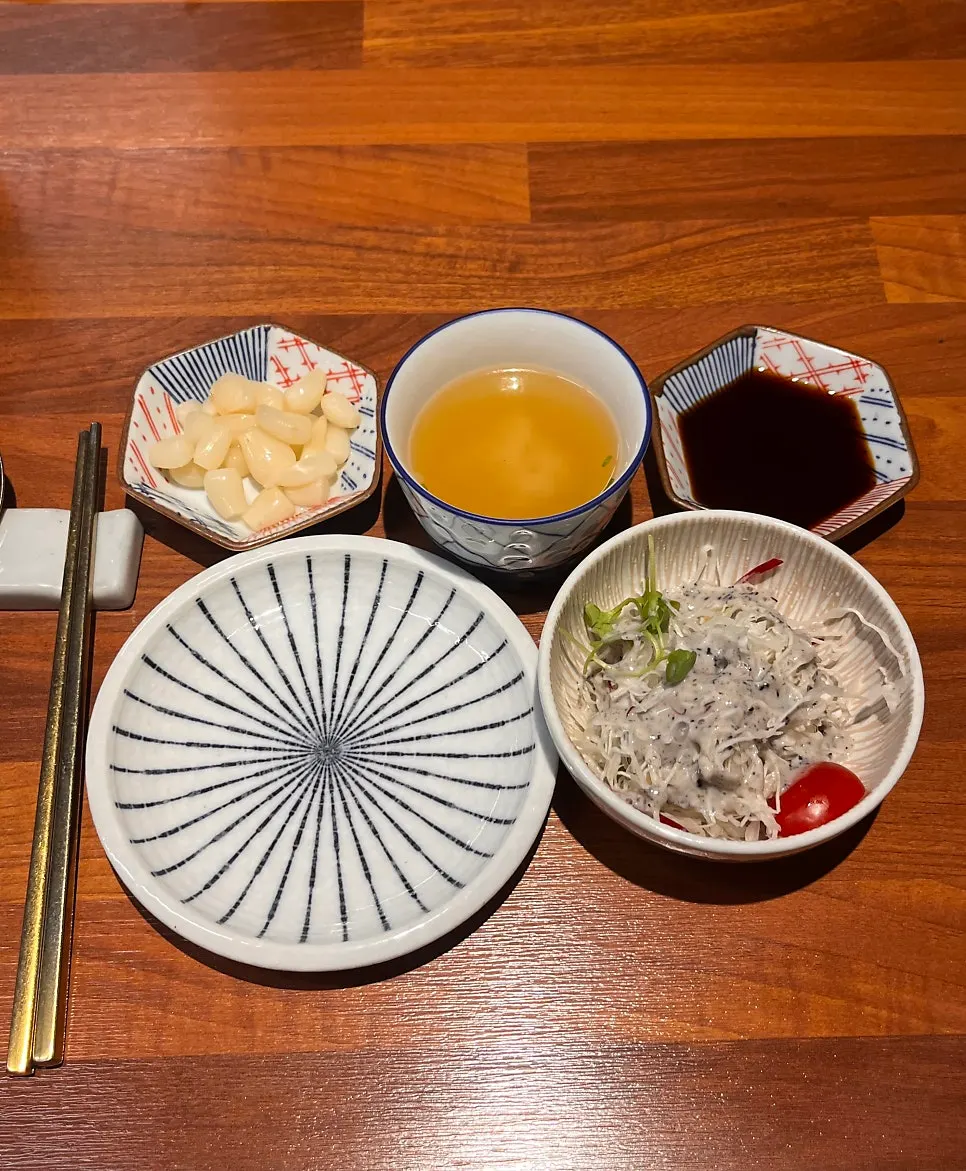 Soy sauce and pickled ginger set on the table
