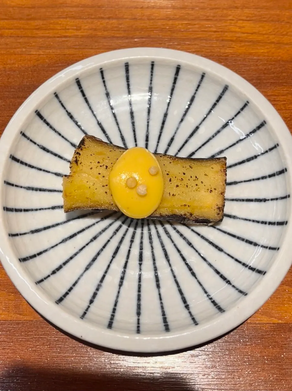 A single piece of the signature eggplant sushi