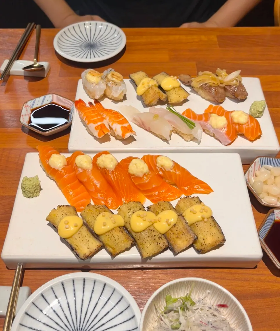 Cross-section of salmon sushi showing the dark reddish rice