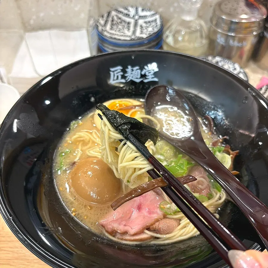 Noodles lifted up from the tonkotsu ramen