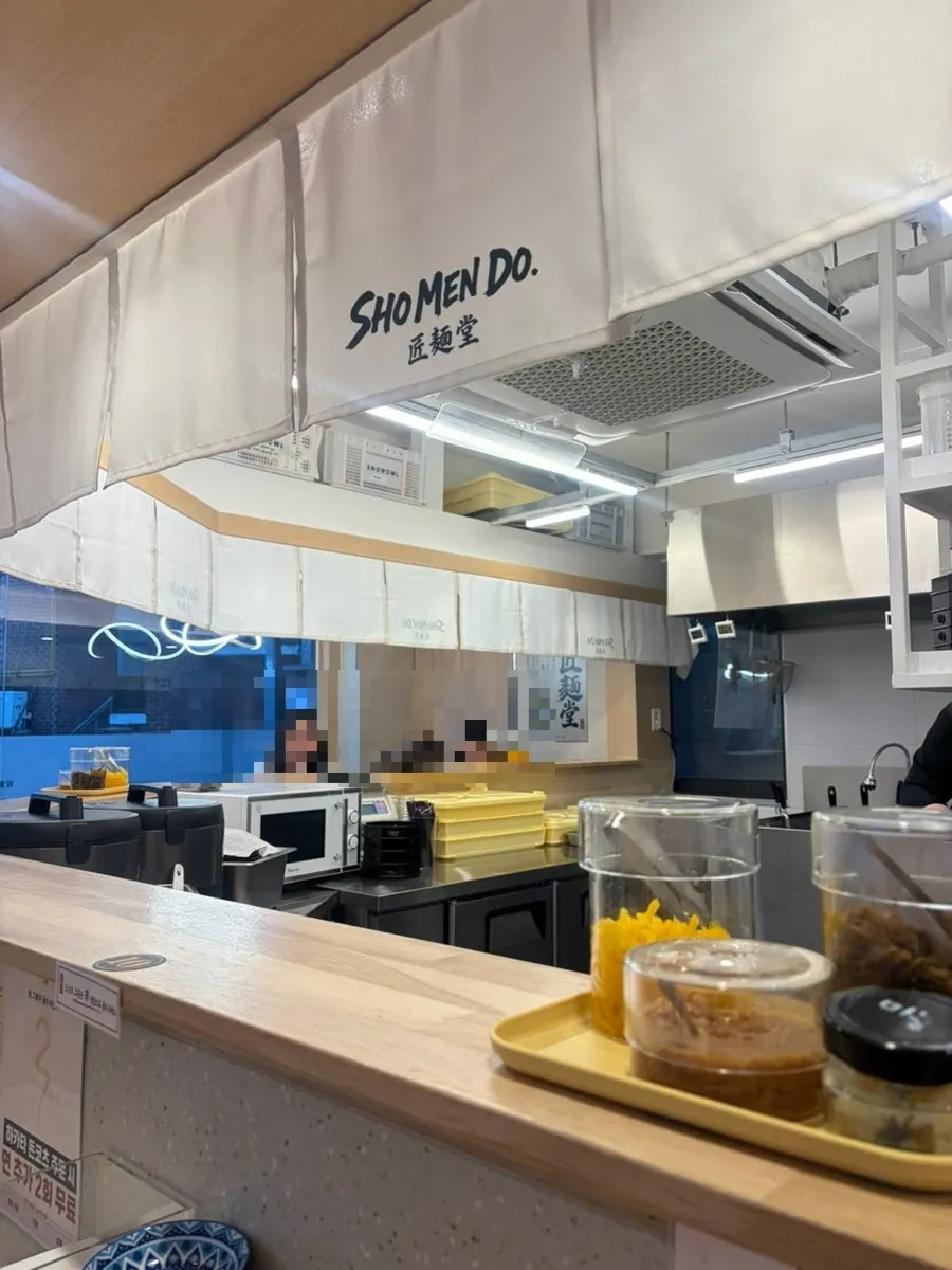 Seating at Shomendo with a view of the open kitchen