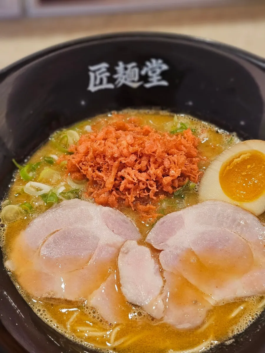 Shrimp tonkotsu ramen topped with chashu and a seasoned egg