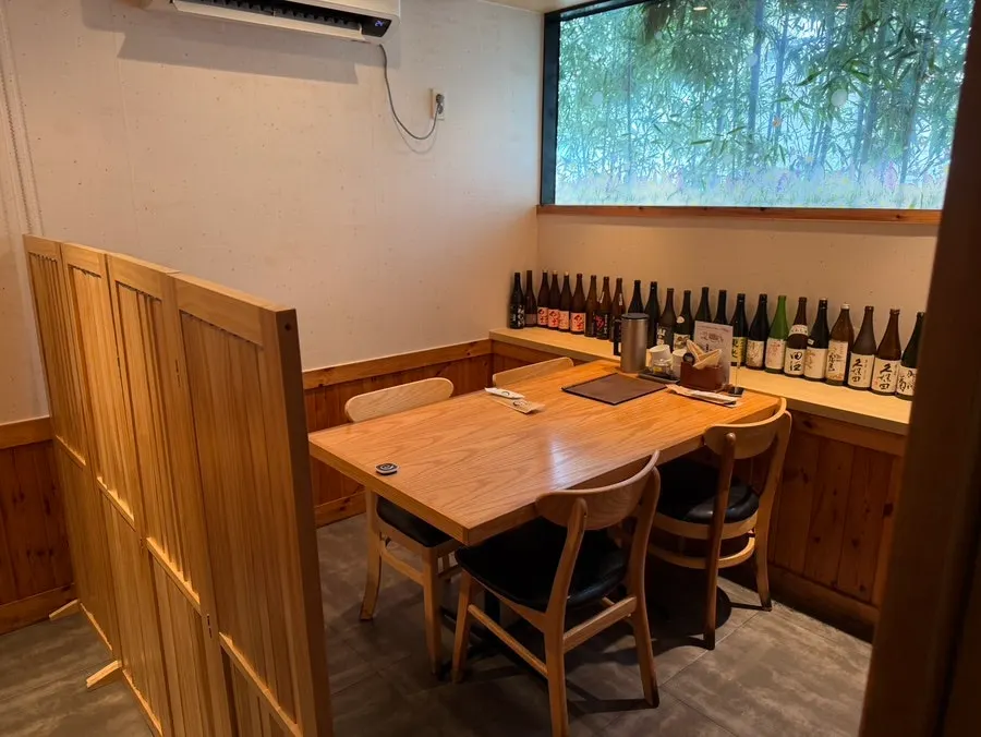 Calm wood-toned table seating inside Shunsaikubo Hwamyeong