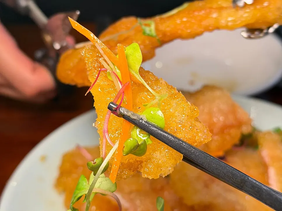 A piece of guobaorou coated in sweet and tangy sauce