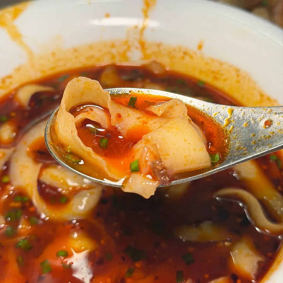 Noodle strands soaked in the broth