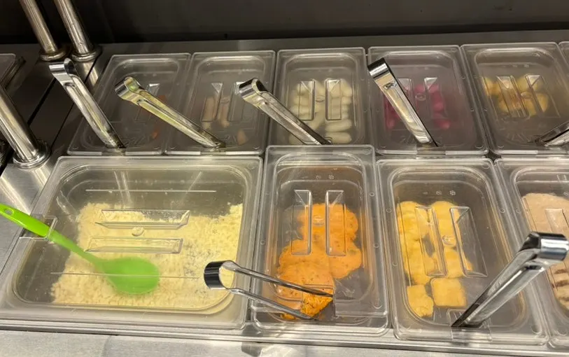 Side dish display with dumplings, corn dogs and tteokgalbi
