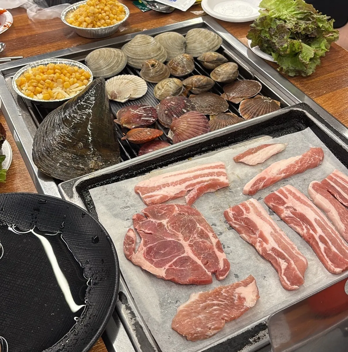 Shellfish and meat placed on the grill