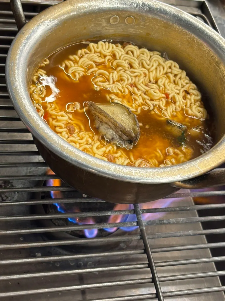 Close-up of steamed shellfish with shells open