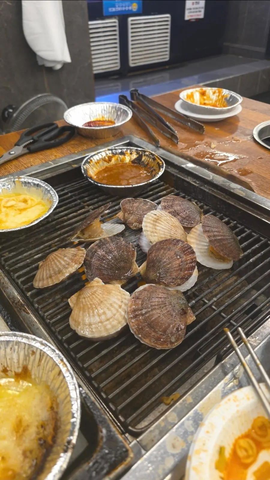 Shellfish and meat grilling on the pan