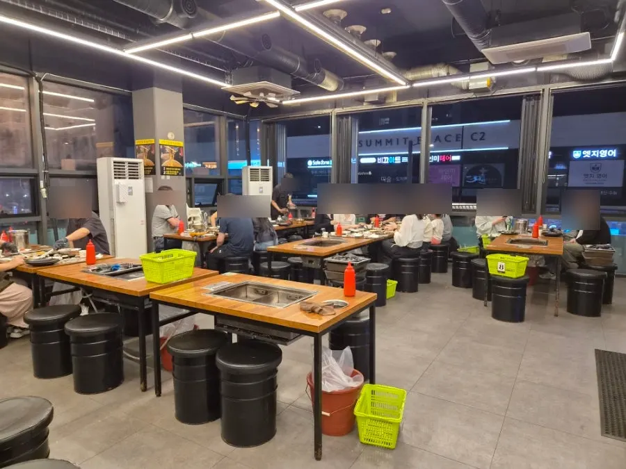 Interior of Unlimited Refill Grilled Shellfish Siheung Baegot Branch, busy on a Friday evening