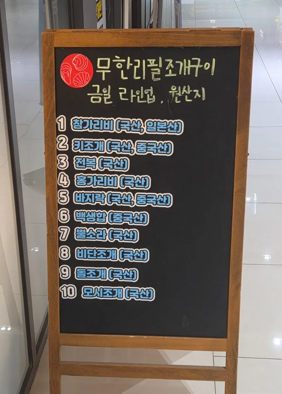 Sign listing the day's shellfish lineup: bay scallops, razor clams, abalone