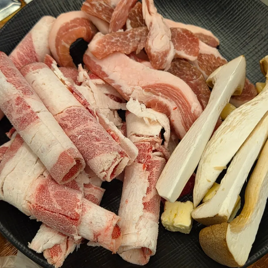 Pork jowl and beef brisket from the self-bar, with kimchi and pickled radish