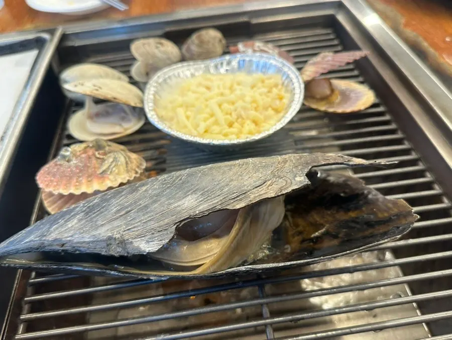 Shellfish opening up on the grill plate