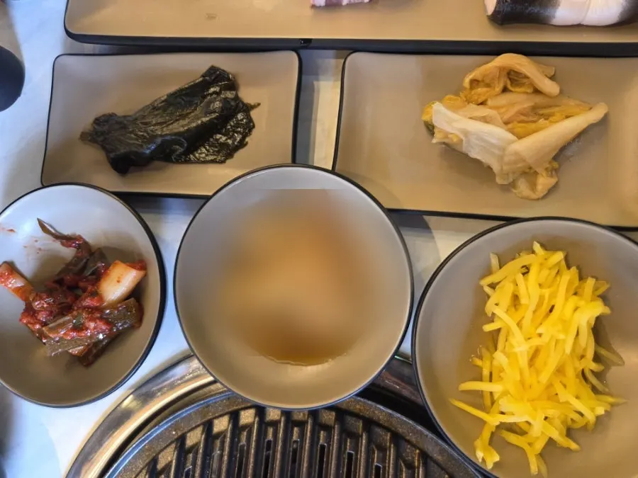 First table setting with aged kimchi and green onion kimchi as basic side dishes