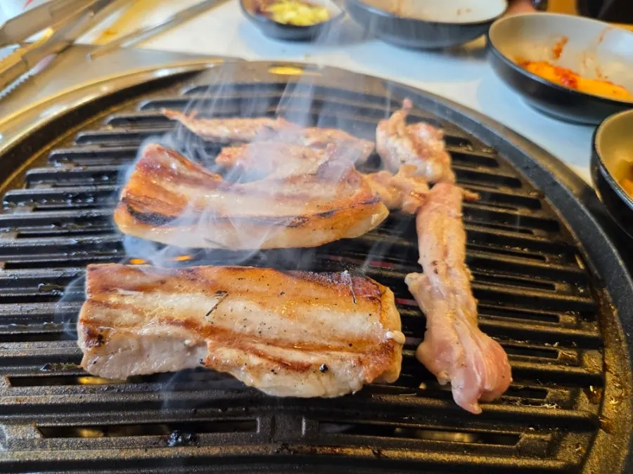 Freshwater eel standing upright on the charcoal grill