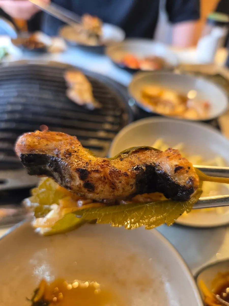 Meat and side dishes piled on a lettuce wrap