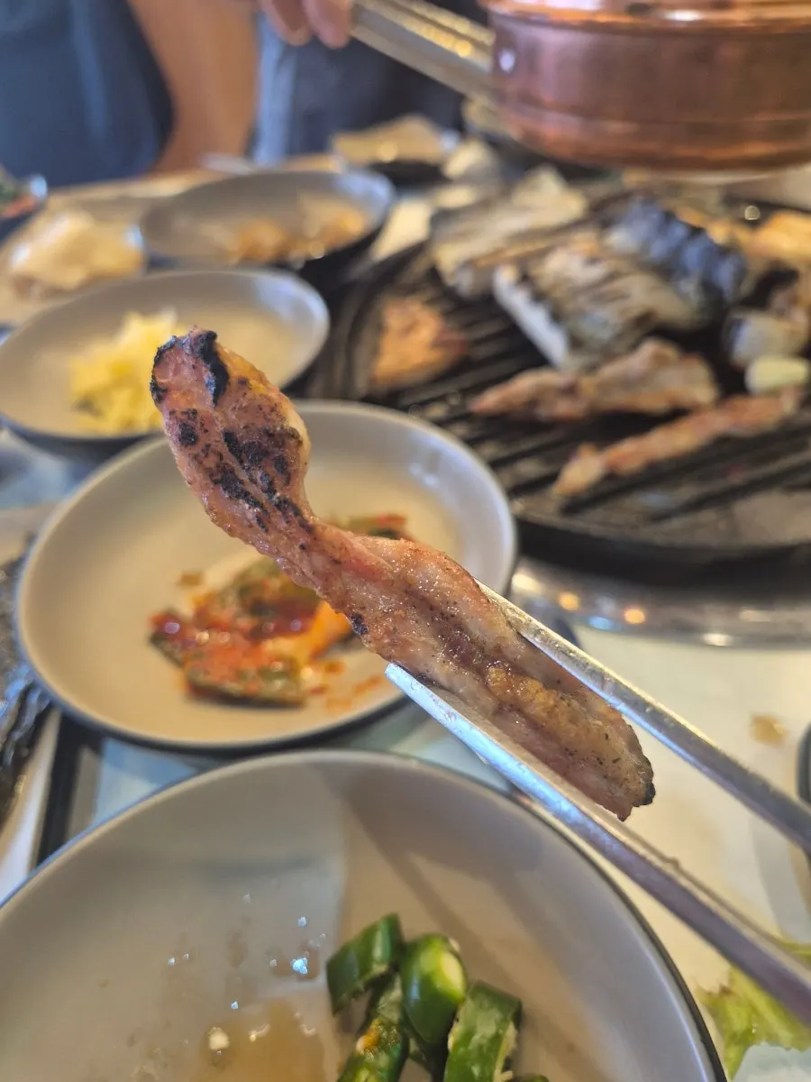A piece of pork belly dipped in ssamjang