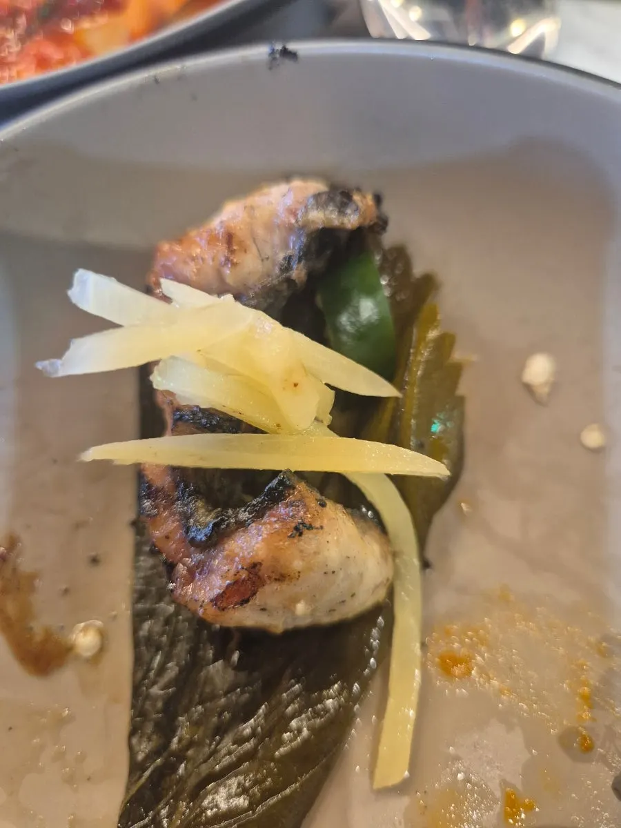 A piece of eel topped with ginger