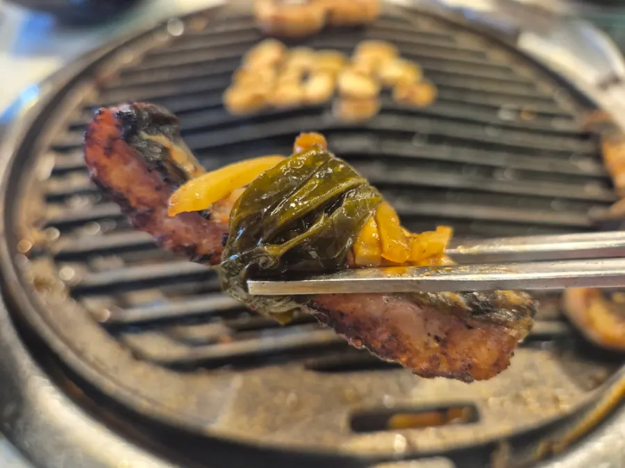 Final bite of eel with perilla leaf and ginger