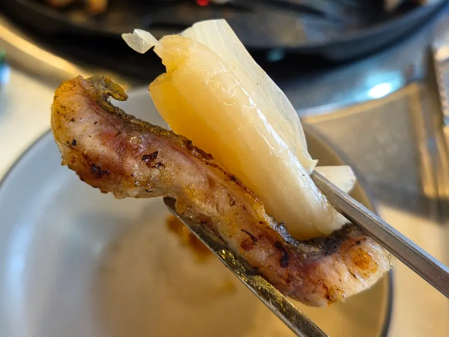 Eel cut into bite-sized pieces and stood up to grill