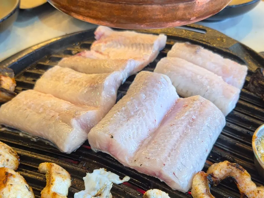 Golden-grilled eel next to rinsed aged kimchi