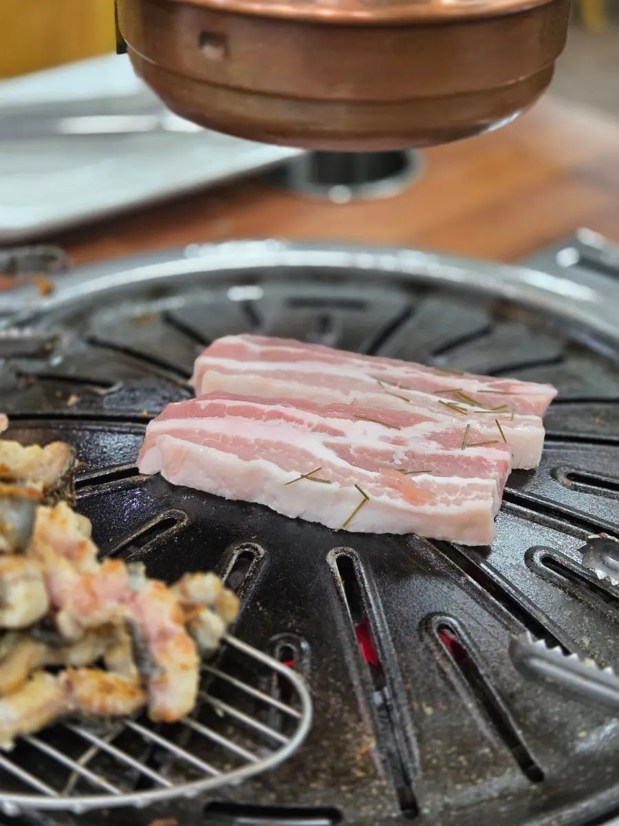 Next batch of eel placed on the grill