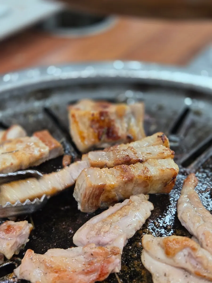 Pork belly and chicken neck grilling on the pan