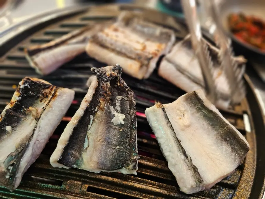 Freshwater eel grilling over a charcoal brazier