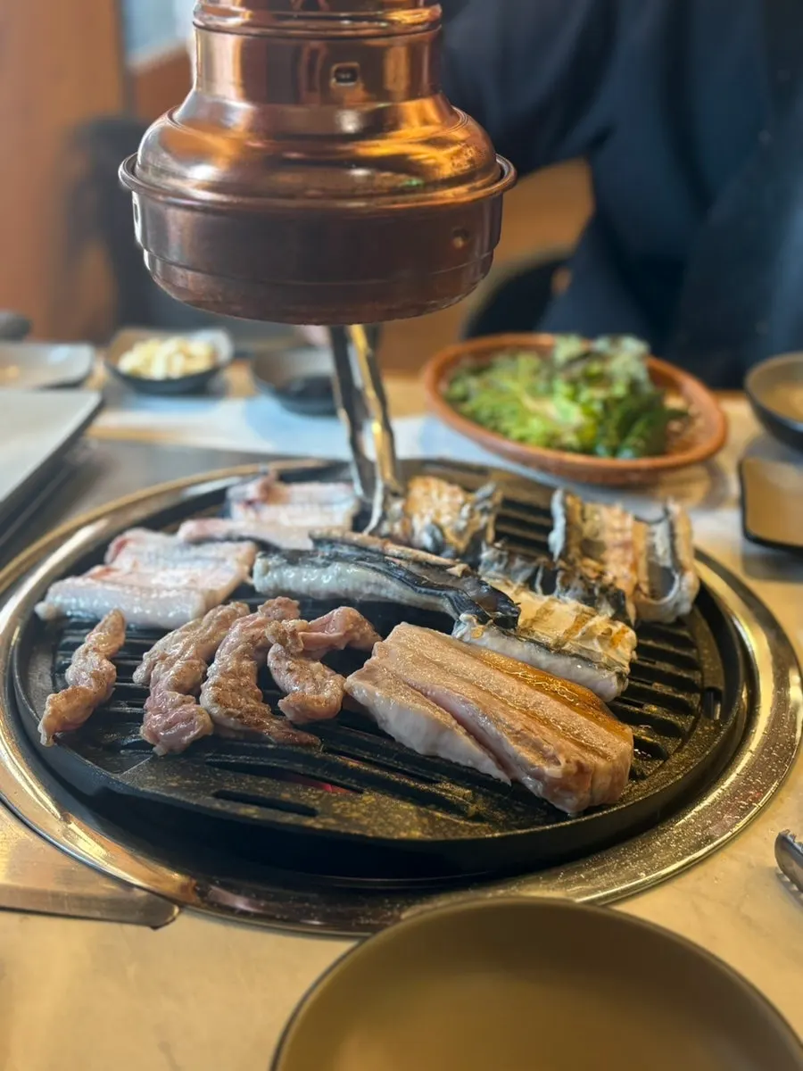 Table set with side dishes and eel sauce