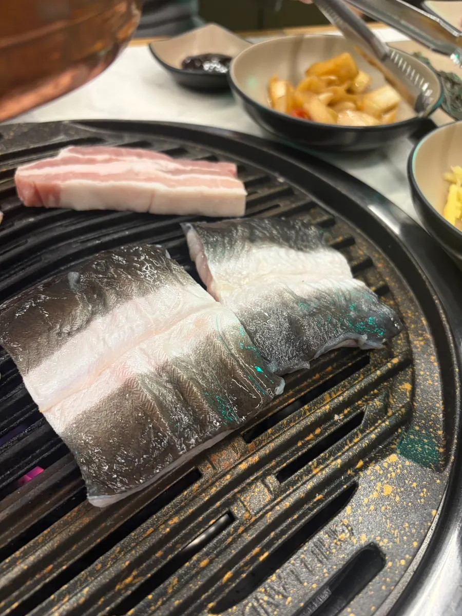 Fresh freshwater eel laid on the grill in big pieces