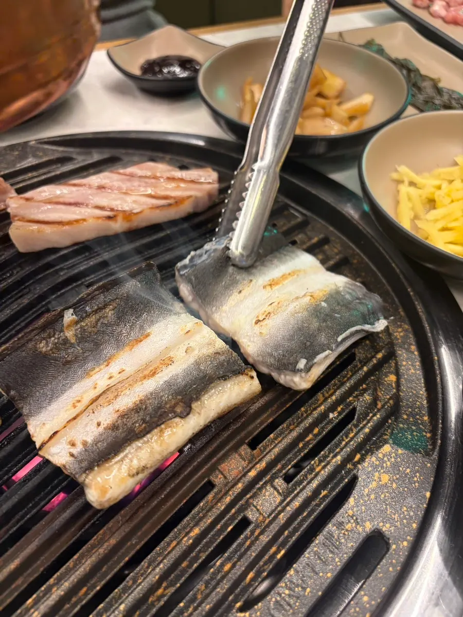 Freshwater eel cooking to a golden brown