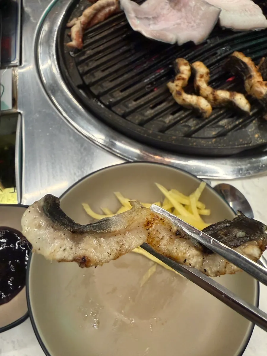 Duck neck cooking on the grill