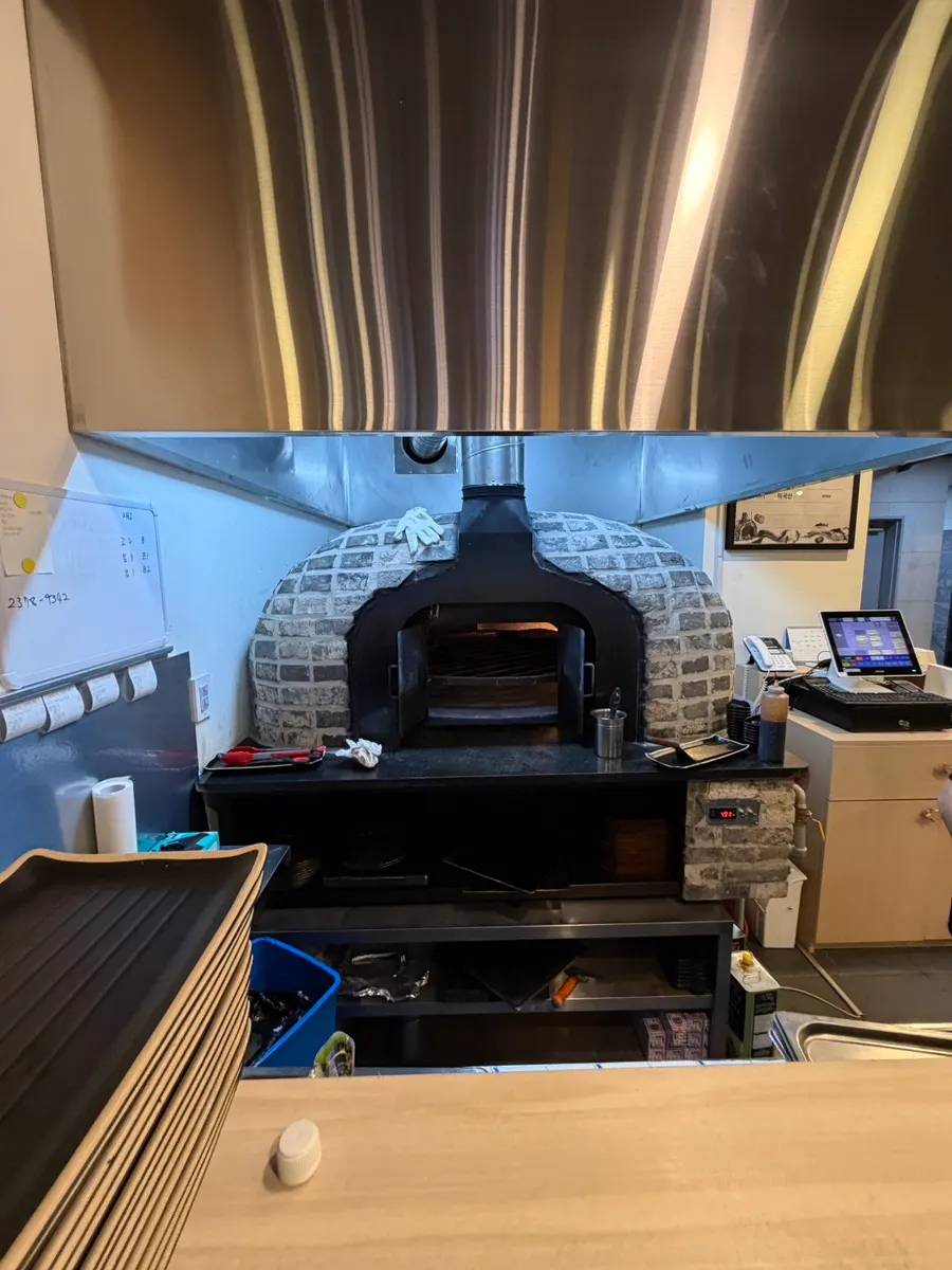 Wood-fired oven space visible in the restaurant