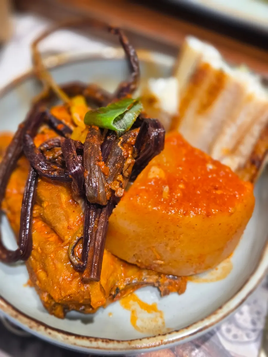 Braised mackerel with a large chunk of radish