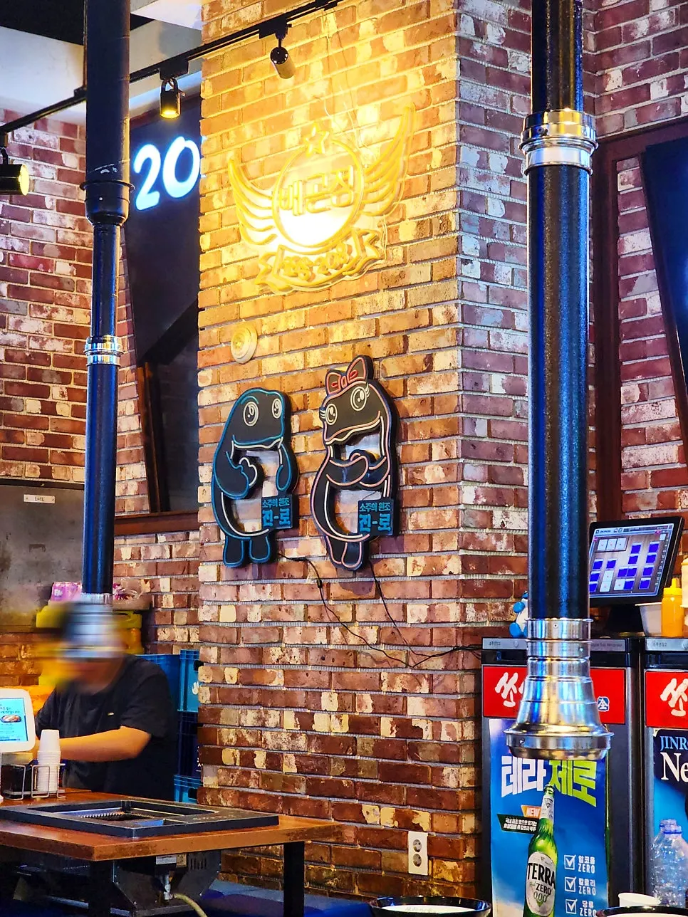 Korean BBQ restaurant interior with red brick and lighting